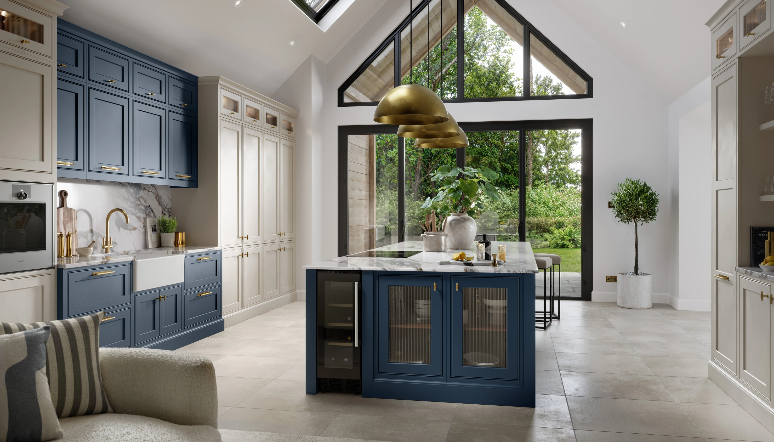 In Frame kitchen with blue and cream cabinetry, marble worktops and a central island